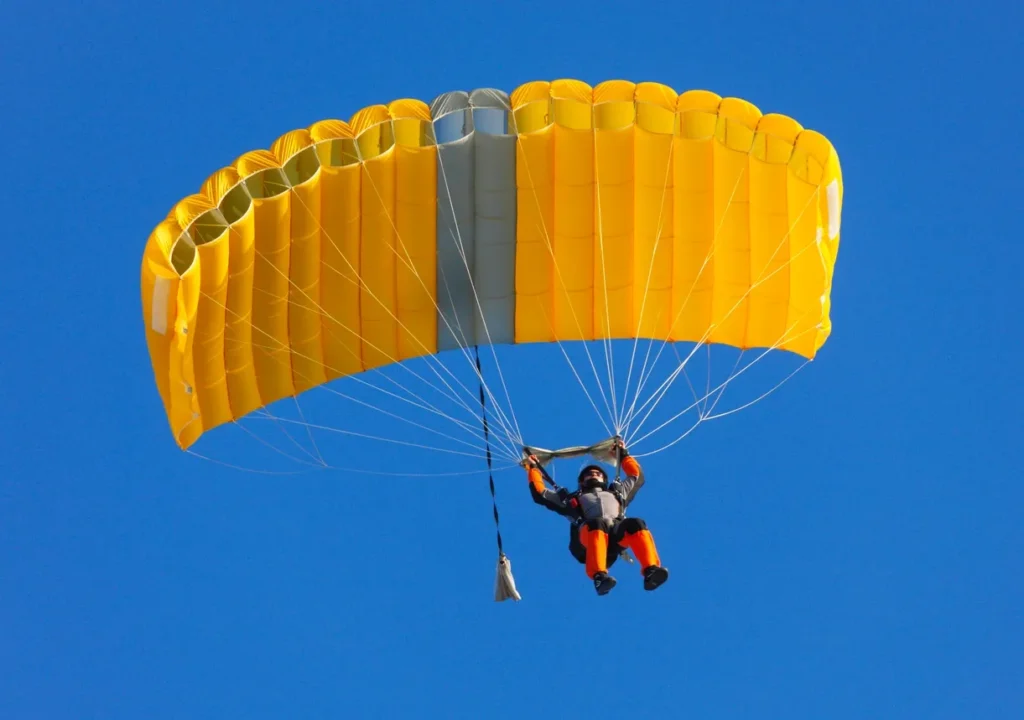 Yellow main canopy flying in a blue sky