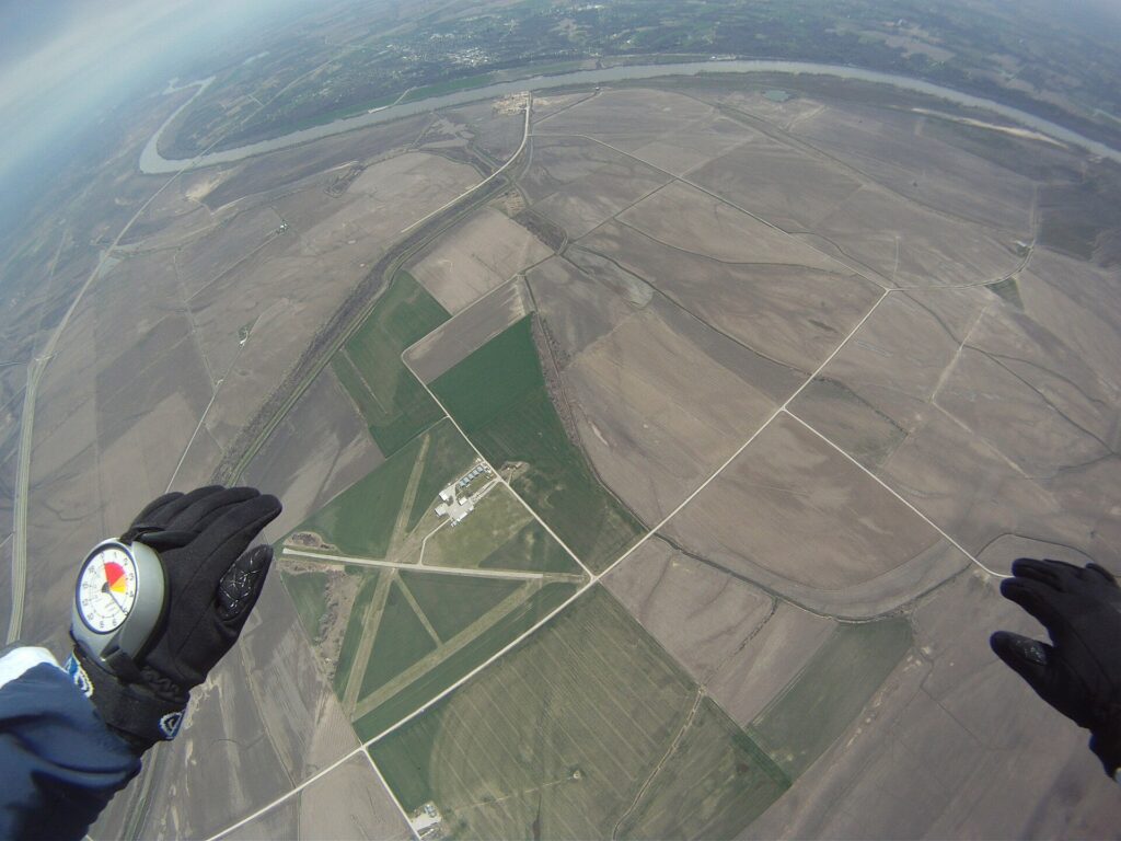 Analogue altimeter on a skydiver’s hand in freefall